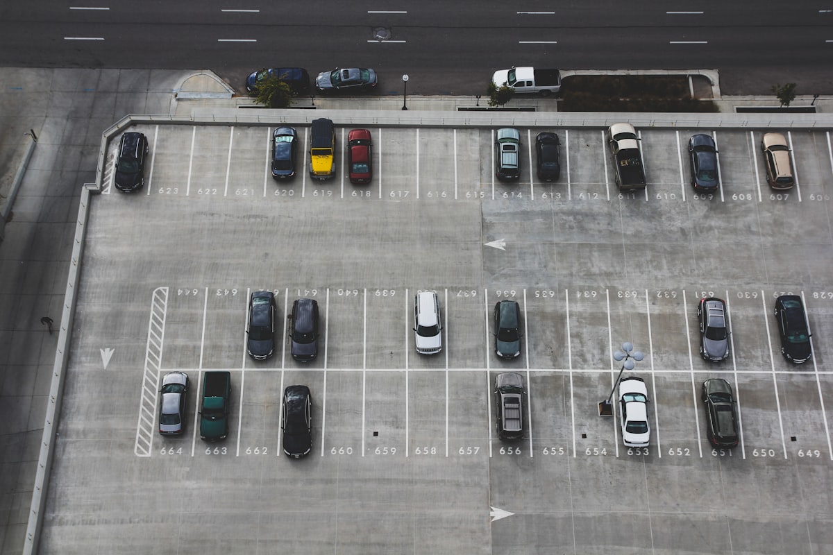 Rows of vehicles at a UK car auction compound awaiting collection